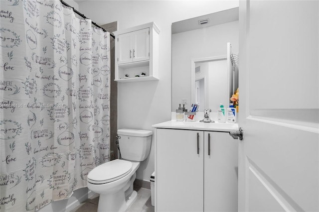 bathroom with vanity, toilet, and tile patterned flooring