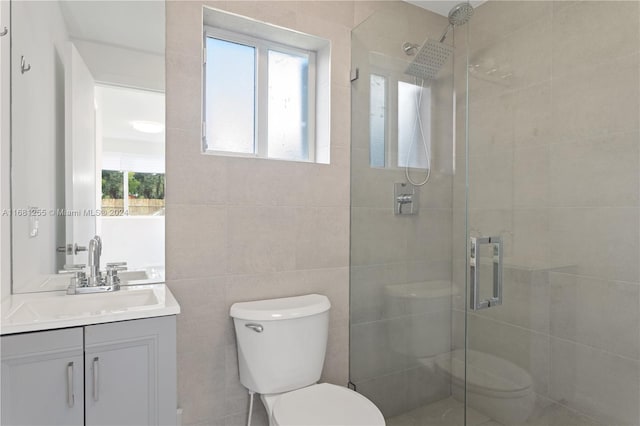 bathroom with toilet, vanity, and plenty of natural light