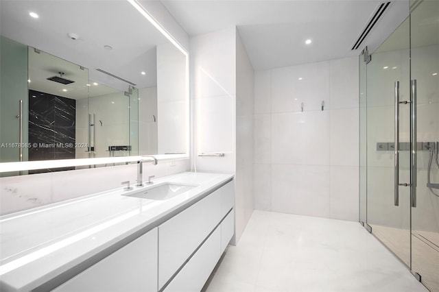 bathroom with vanity, walk in shower, and tile patterned floors