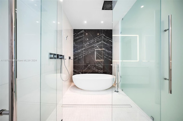 bathroom featuring tile walls, separate shower and tub, and tile patterned flooring