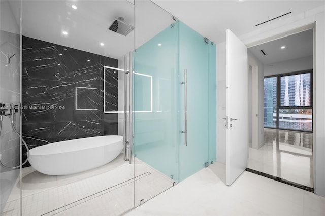 bathroom featuring tile walls, shower with separate bathtub, and tile patterned floors