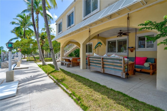 exterior space with ceiling fan