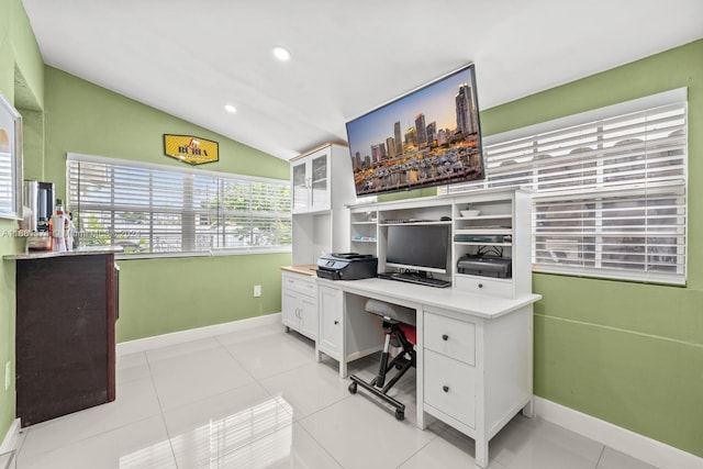 tiled office space featuring lofted ceiling and built in desk