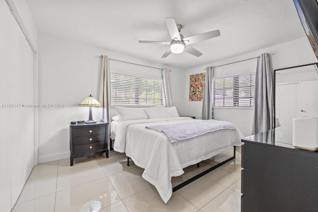 tiled bedroom featuring ceiling fan