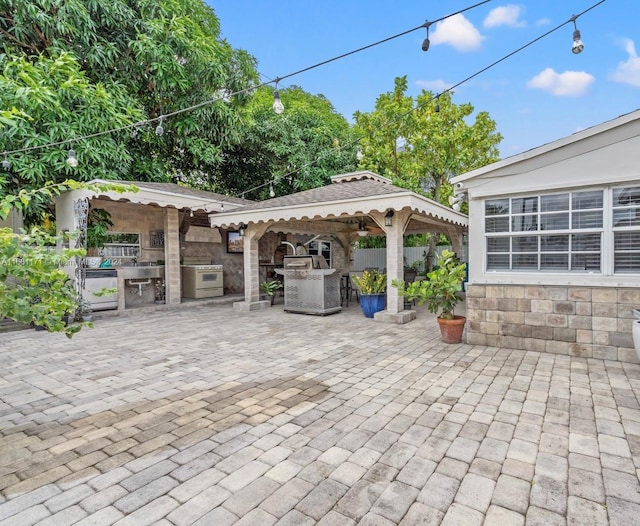 view of patio featuring area for grilling, a gazebo, and exterior bar