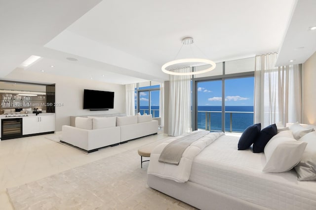 bedroom with access to outside, wine cooler, expansive windows, and a chandelier