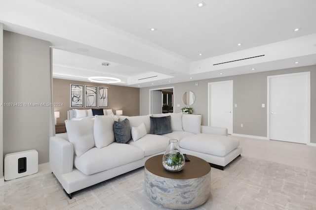 living room with a tray ceiling