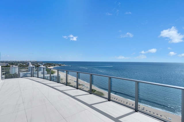 balcony featuring a water view and a beach view