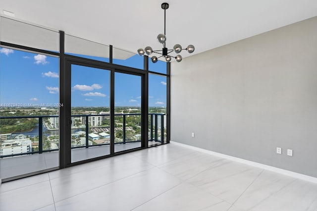 unfurnished room featuring expansive windows, a chandelier, and tile patterned flooring