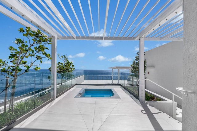 view of swimming pool with an in ground hot tub and a water view