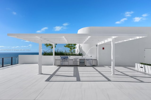 view of patio / terrace with a water view, a pergola, area for grilling, and grilling area