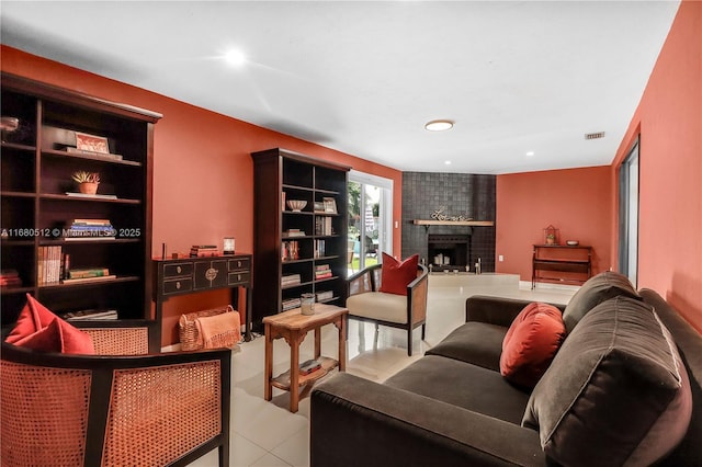 sitting room featuring light tile patterned floors and a fireplace