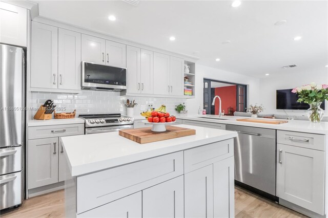 kitchen featuring white cabinets, stainless steel appliances, and sink