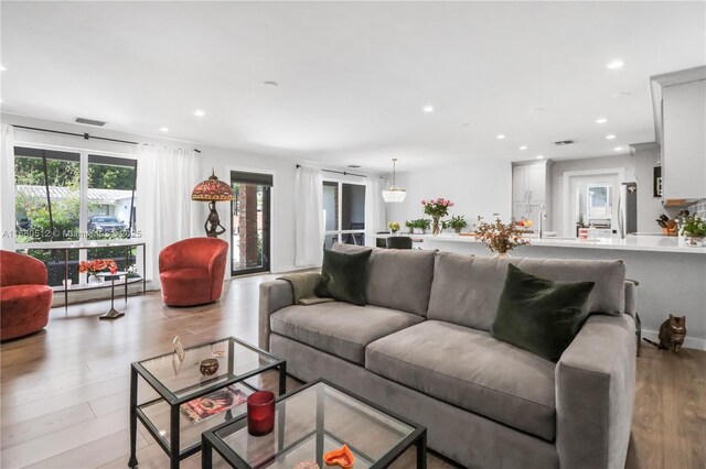 living room with light hardwood / wood-style flooring