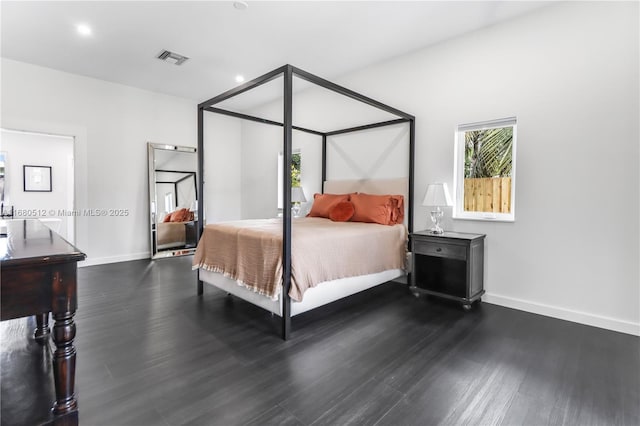 bedroom with dark hardwood / wood-style flooring