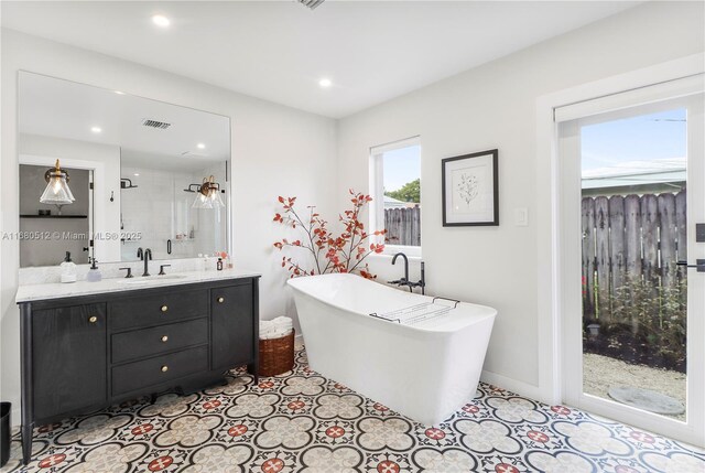 bathroom with vanity and plus walk in shower