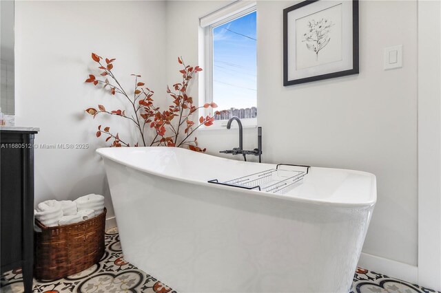 bathroom featuring tile patterned flooring and a tub to relax in