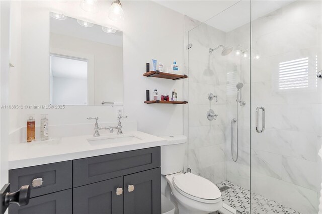 bathroom featuring vanity, toilet, and walk in shower