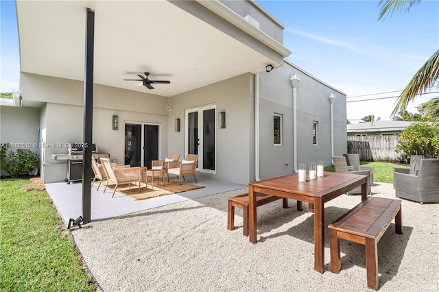 rear view of property with an outdoor living space, ceiling fan, and a patio