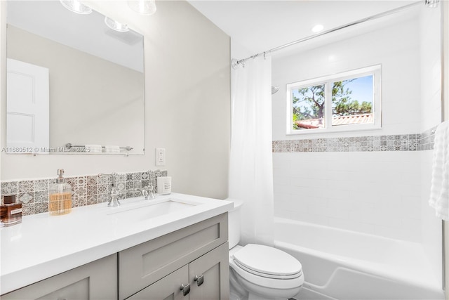 full bathroom with vanity, toilet, shower / bath combo with shower curtain, and backsplash