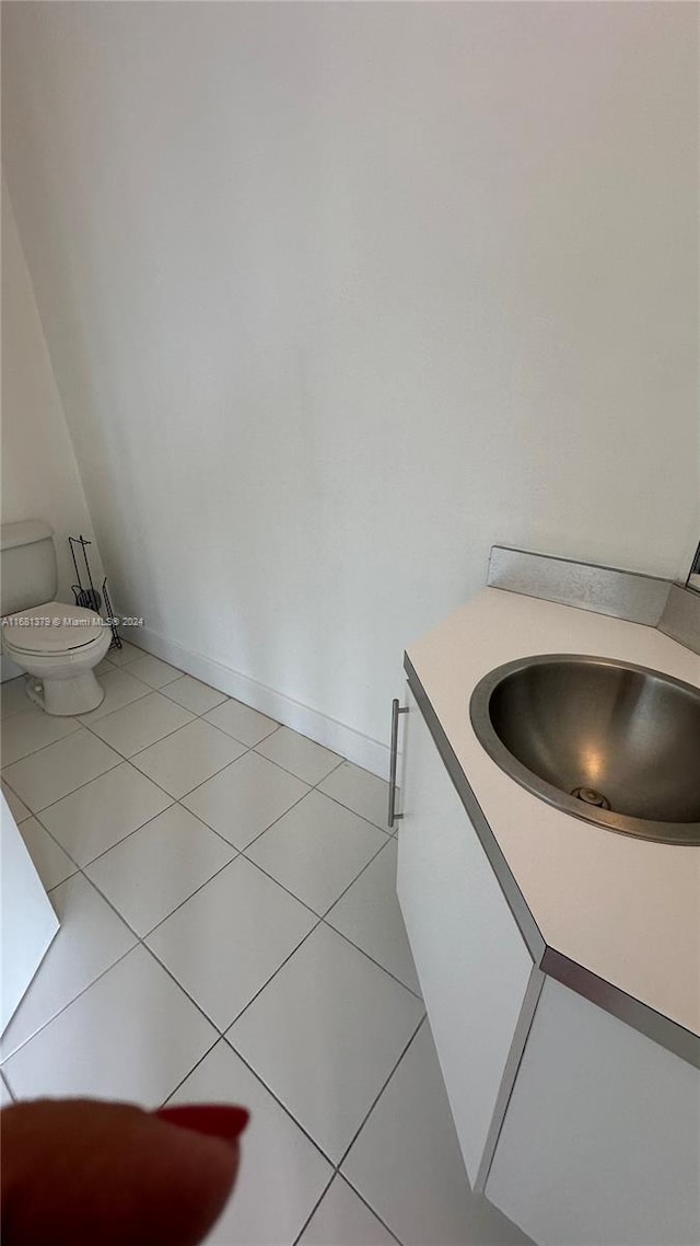 bathroom with vanity, toilet, and tile patterned floors