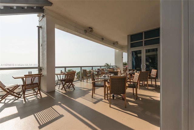 view of patio / terrace featuring a water view and a balcony