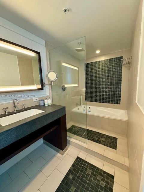 bathroom featuring vanity, plus walk in shower, and tile patterned flooring