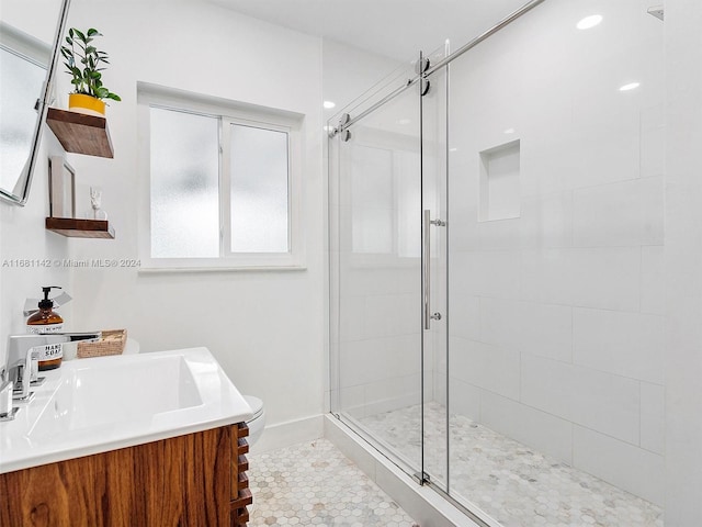 bathroom with toilet, vanity, an enclosed shower, and tile patterned flooring