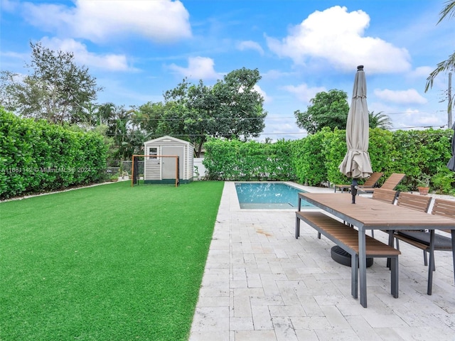 view of swimming pool with a shed, a yard, and a patio area