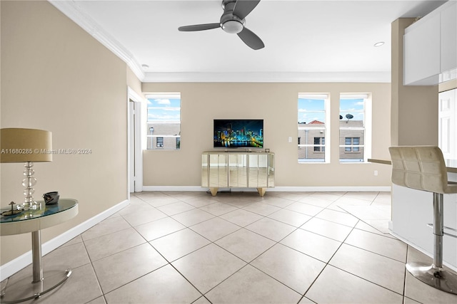 unfurnished living room with ornamental molding, light tile patterned flooring, ceiling fan, and plenty of natural light