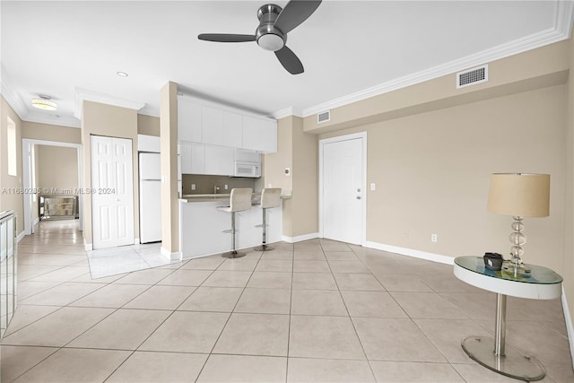 unfurnished living room featuring ornamental molding, ceiling fan, and light tile patterned floors