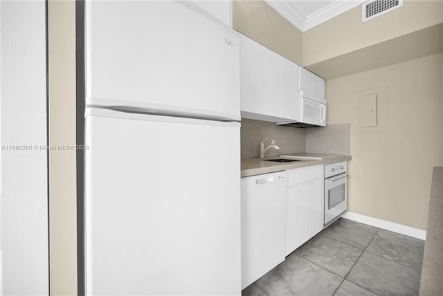 kitchen featuring ornamental molding, white cabinetry, sink, and white appliances