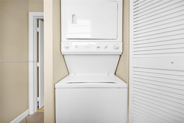 clothes washing area featuring stacked washer and dryer