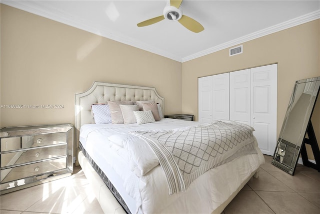 bedroom with a closet, ceiling fan, ornamental molding, and light tile patterned flooring