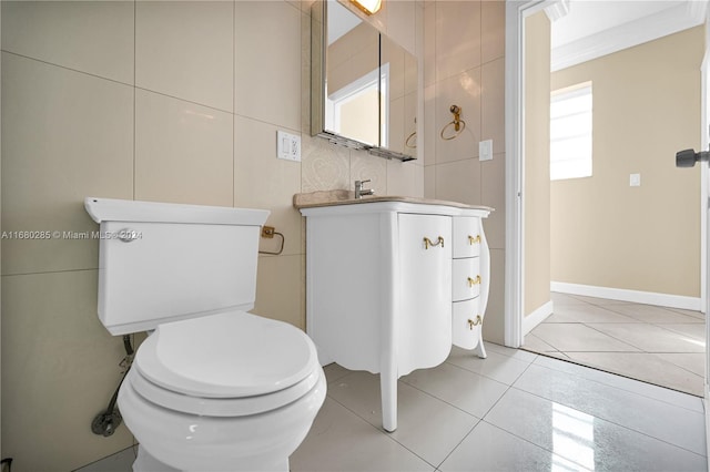 bathroom with toilet, crown molding, a healthy amount of sunlight, and tile patterned flooring