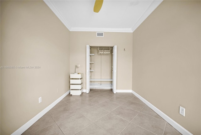 unfurnished room featuring ornamental molding, ceiling fan, and light tile patterned floors