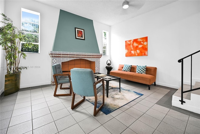 sitting room featuring tile patterned floors and ceiling fan