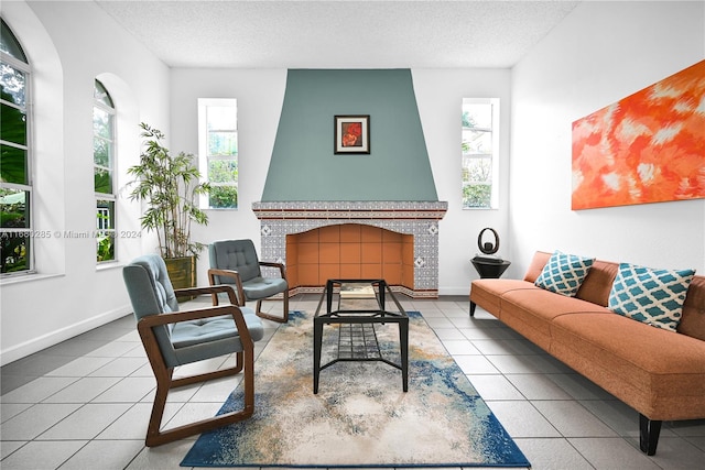 living room with a healthy amount of sunlight, a textured ceiling, and a fireplace