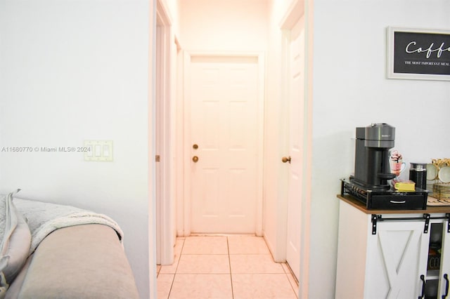 hall featuring light tile patterned floors