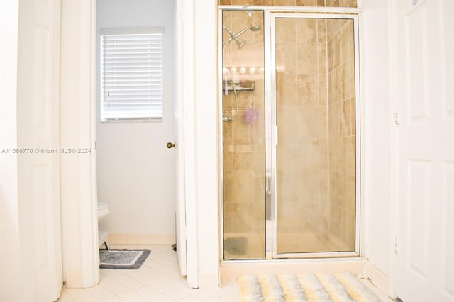 bathroom with tile patterned floors and walk in shower