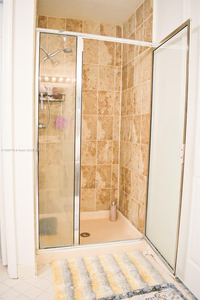 bathroom featuring tile patterned flooring and walk in shower