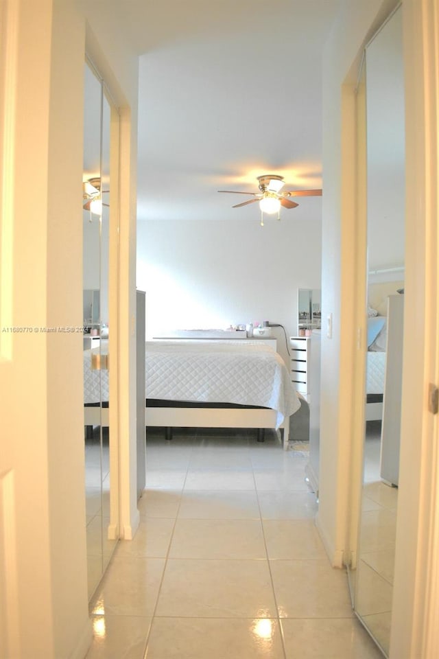 tiled bedroom featuring ceiling fan