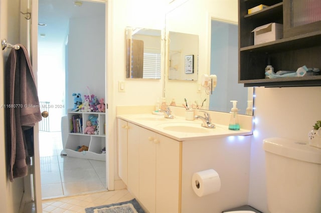 bathroom featuring tile patterned floors, vanity, and toilet