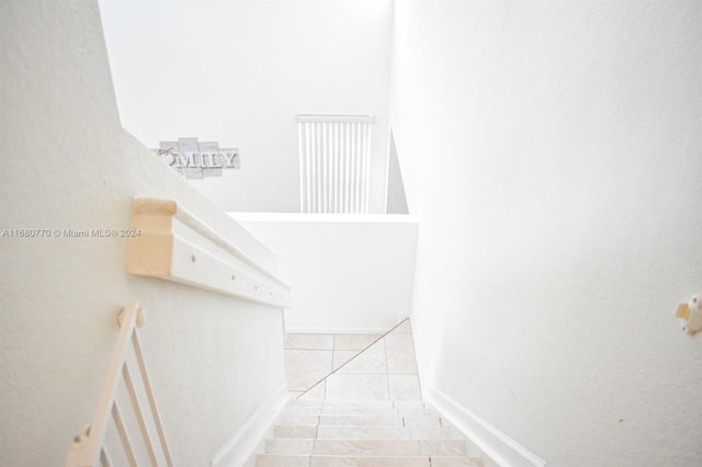 staircase featuring tile patterned flooring