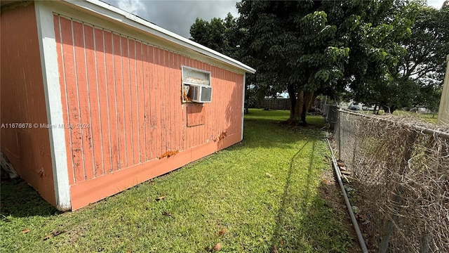 view of side of property featuring cooling unit and a lawn