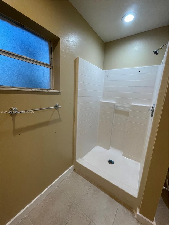 bathroom with walk in shower and tile patterned flooring