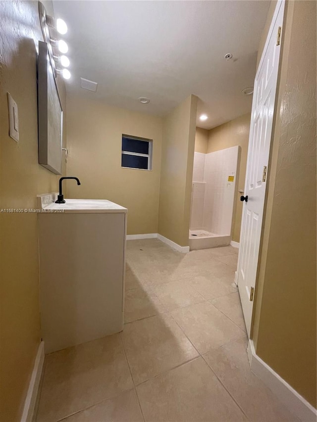 bathroom featuring tile patterned floors, sink, and walk in shower