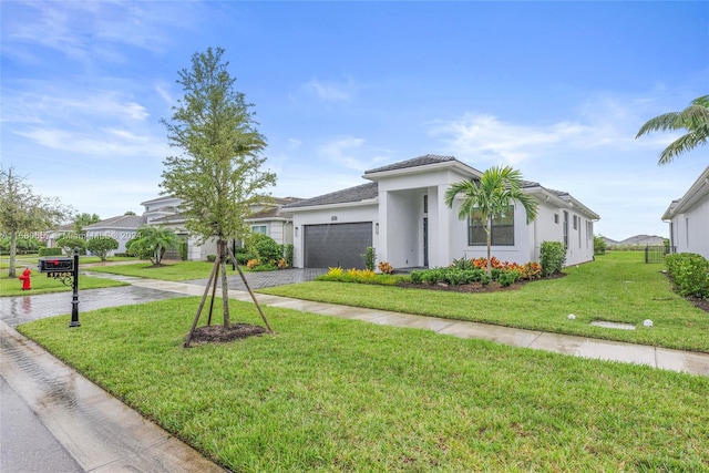 view of front of home featuring a garage and a front lawn