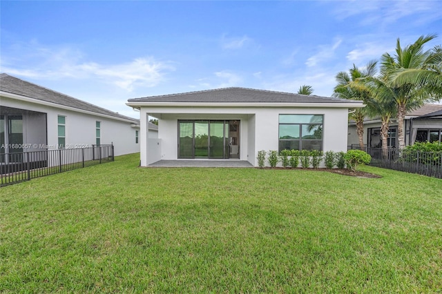 back of property featuring a patio area and a yard