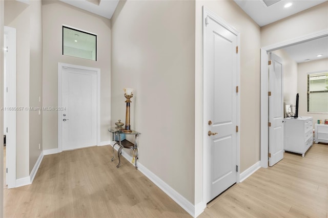 corridor with light hardwood / wood-style flooring